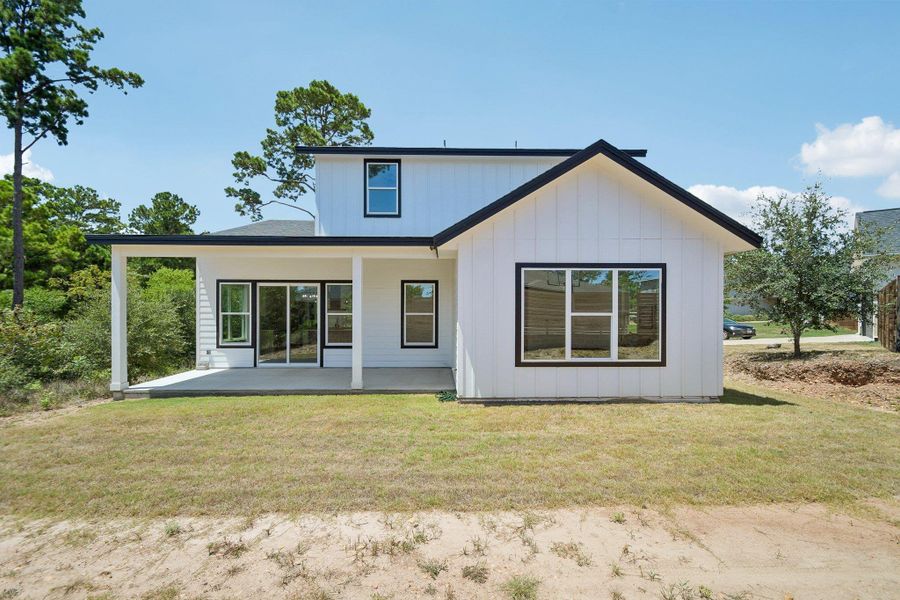 Crisp board and batten siding pairs with black trim on this modern two-story exterior. Crisp board and batten siding pairs with black trim on this modern two-story exterior.