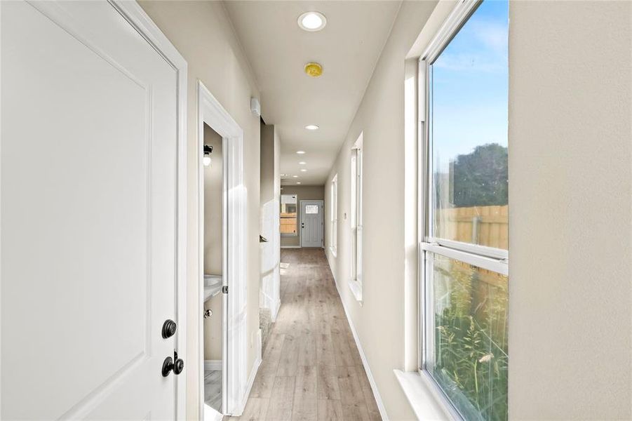 Hallway with light hardwood / wood-style flooring