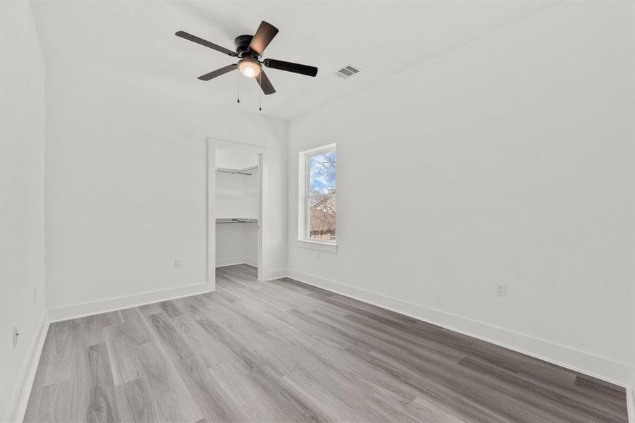 Secondary bedroom with a walk-in closet.