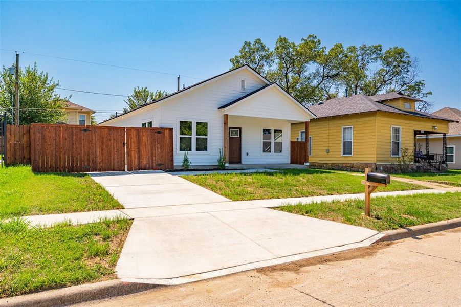 View of front of home featuring covered porch and a shingled roof