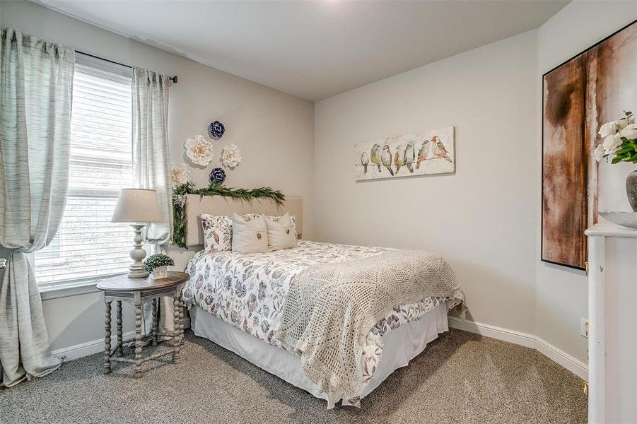 Carpeted bedroom featuring baseboards