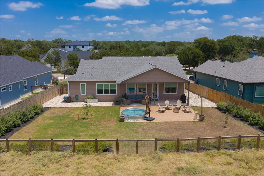 A private backyard oasis with a covered patio, ample seating, and a refreshing above-ground pool.