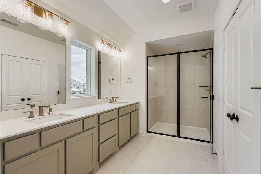 Full bathroom with double vanity, tile patterned flooring, a stall shower, and recessed lighting