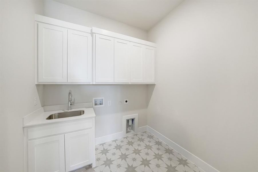 Laundry room with light flooring, cabinet space, washer hookup, and electric dryer hookup Laundry room with light flooring, cabinet space, washer hookup, and electric dryer hookup