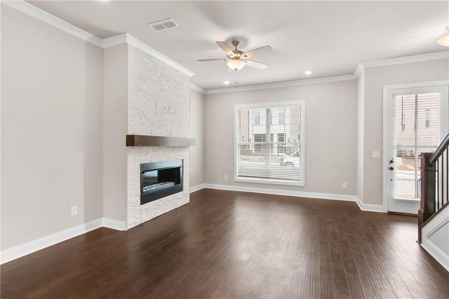 The family room linear fireplace at homesite 102 will have stacked quartzite and a box beam mantel. Photos are not of the exact property but are similar, the home is currently under construction.