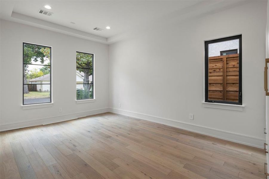 Empty room with light wood finished floors and recessed lighting Empty room with light wood finished floors and recessed lighting