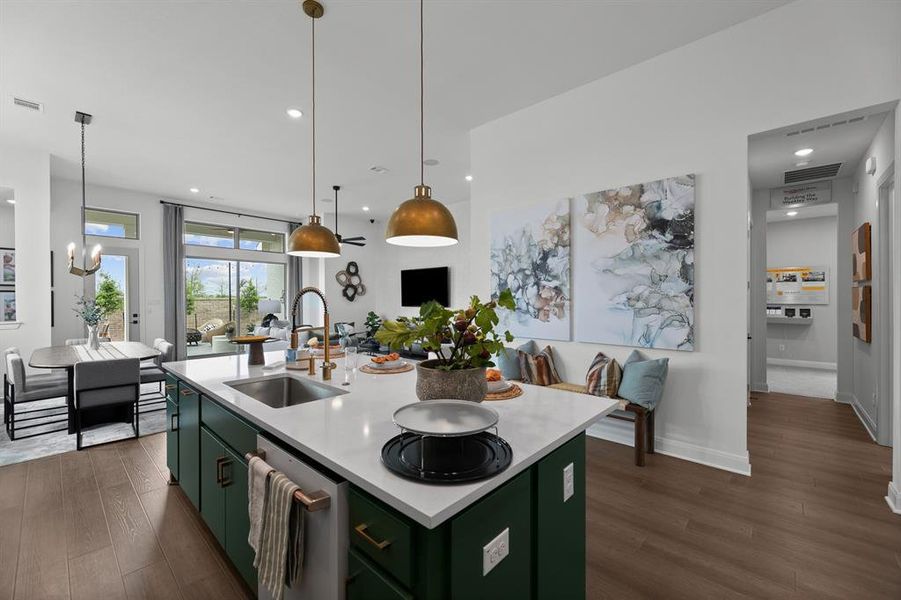 Kitchen featuring green cabinetry, dark wood finished floors, a center island with sink, open floor plan, and stainless steel dishwasher Kitchen featuring green cabinetry, dark wood finished floors, a center island with sink, open floor plan, and stainless steel dishwasher