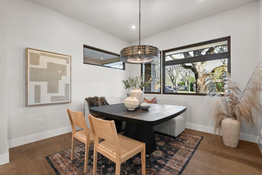 Dining area with dark wood-style floors, recessed lighting, and a chandelier