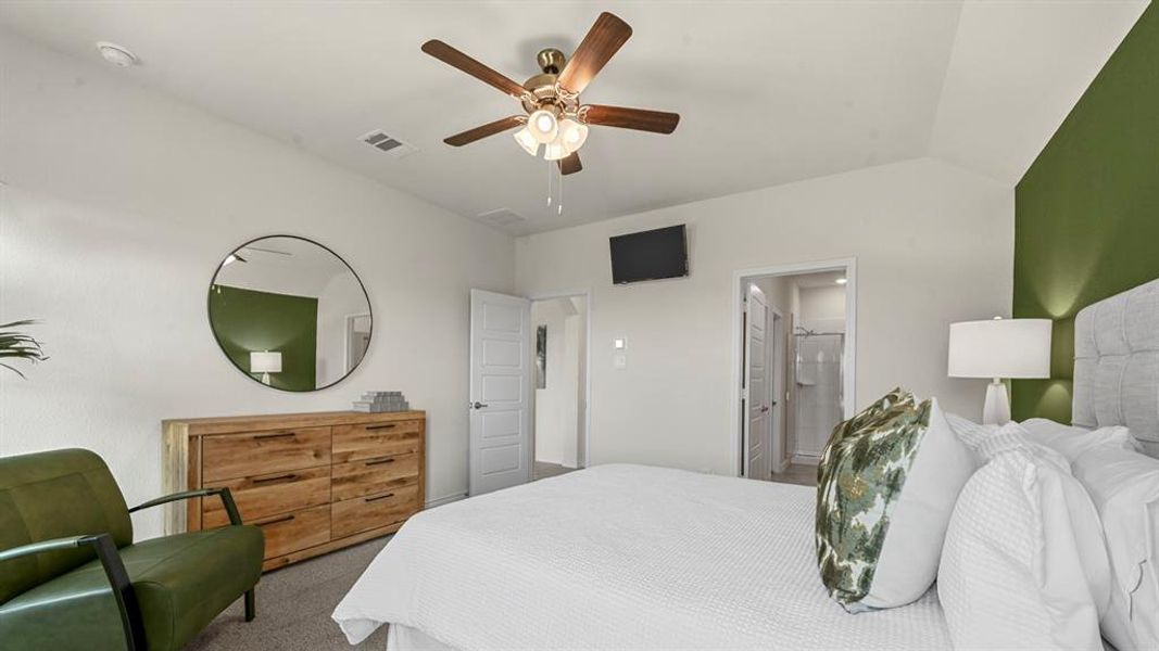 Bedroom featuring carpet floors, a ceiling fan, and connected bathroom