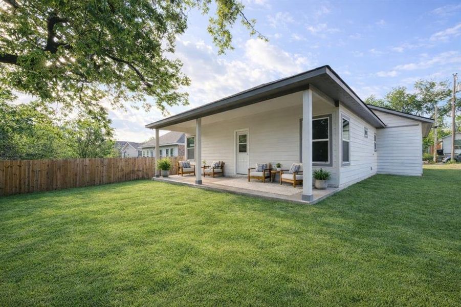 Virtual staging for illustration purposes only.with a well-maintained lawn and a wooden privacy fence