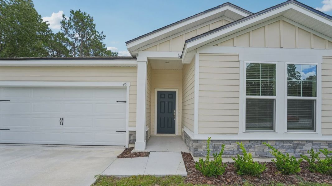 Stone accents add sophistication to this Palm Coast home's exterior at 46 Poplar Drive, enhancing its curb appeal.