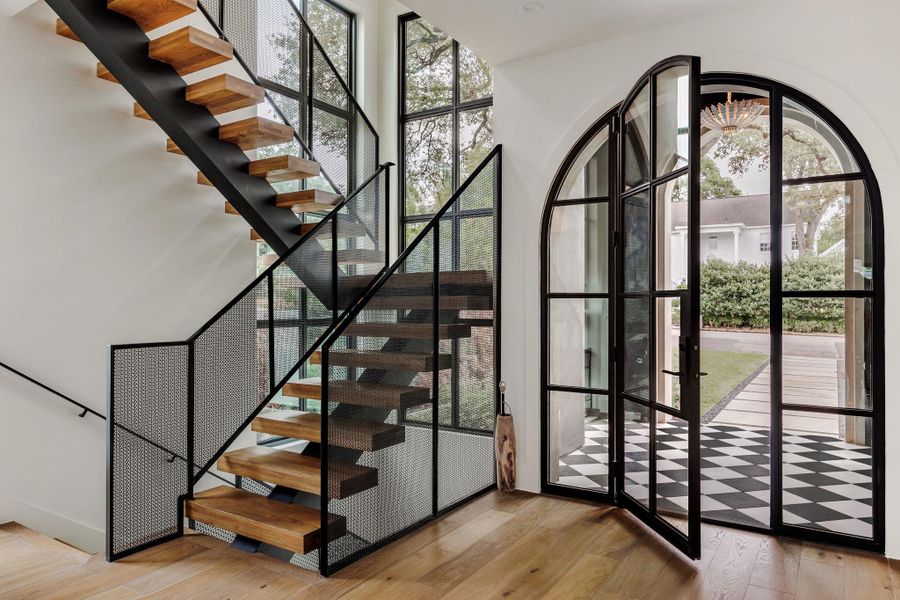 Soaring ceilings, architectural lighting, and warm wood flooring create an immediate sense of calm and elevated design. Soaring ceilings, architectural lighting, and warm wood flooring create an immediate sense of calm and elevated design.