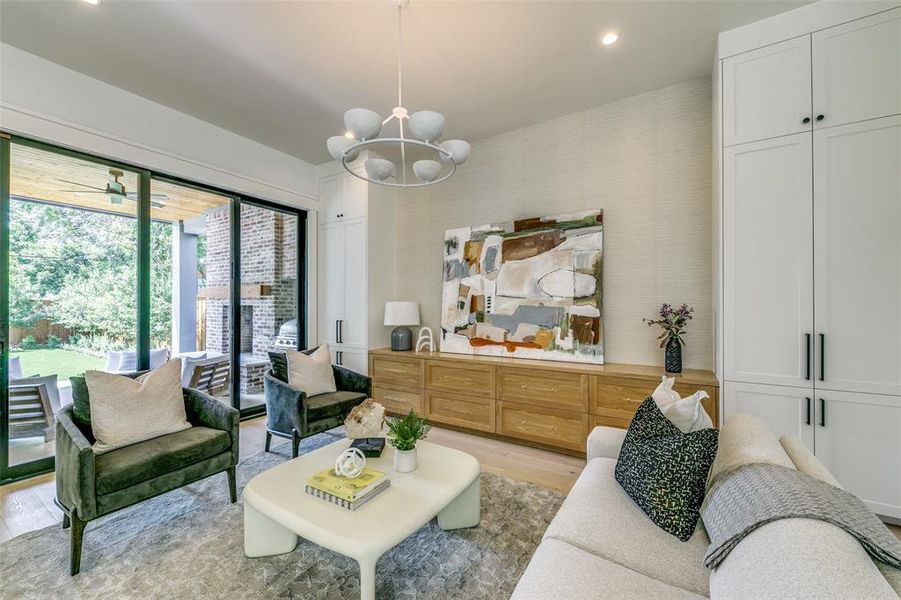 Living room featuring a chandelier and light hardwood / wood-style floors