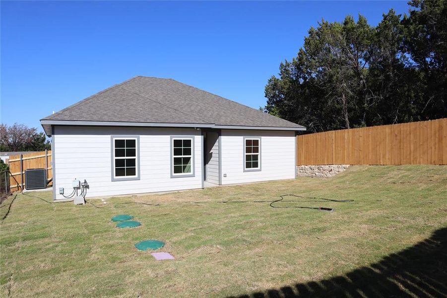 Rear View of property with a lawn