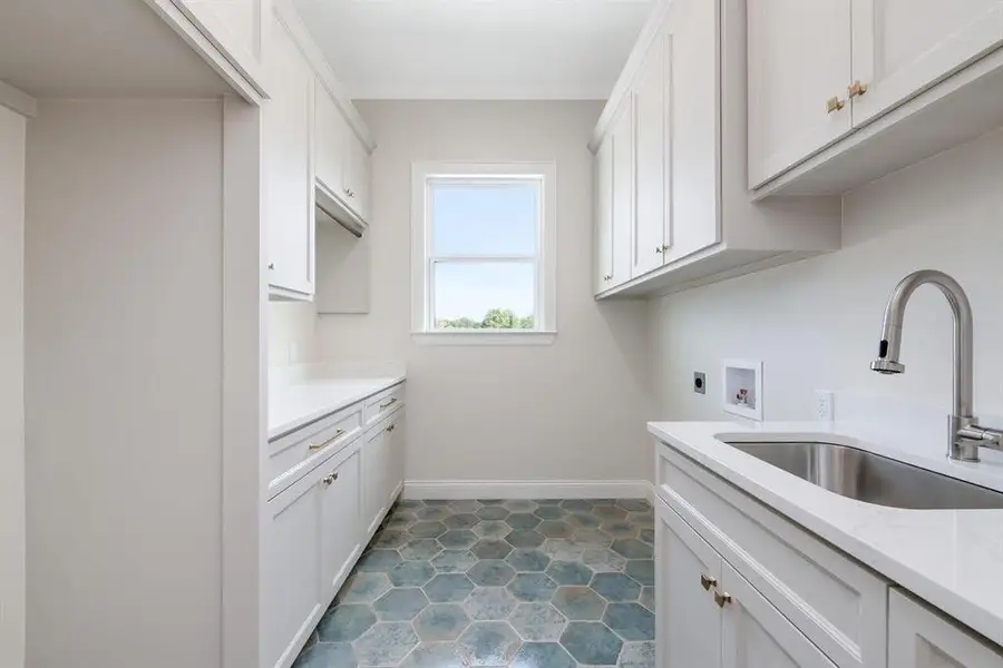 Laundry area featuring cabinet space, electric dryer hookup, and hookup for a washing machine Laundry area featuring cabinet space, electric dryer hookup, and hookup for a washing machine
