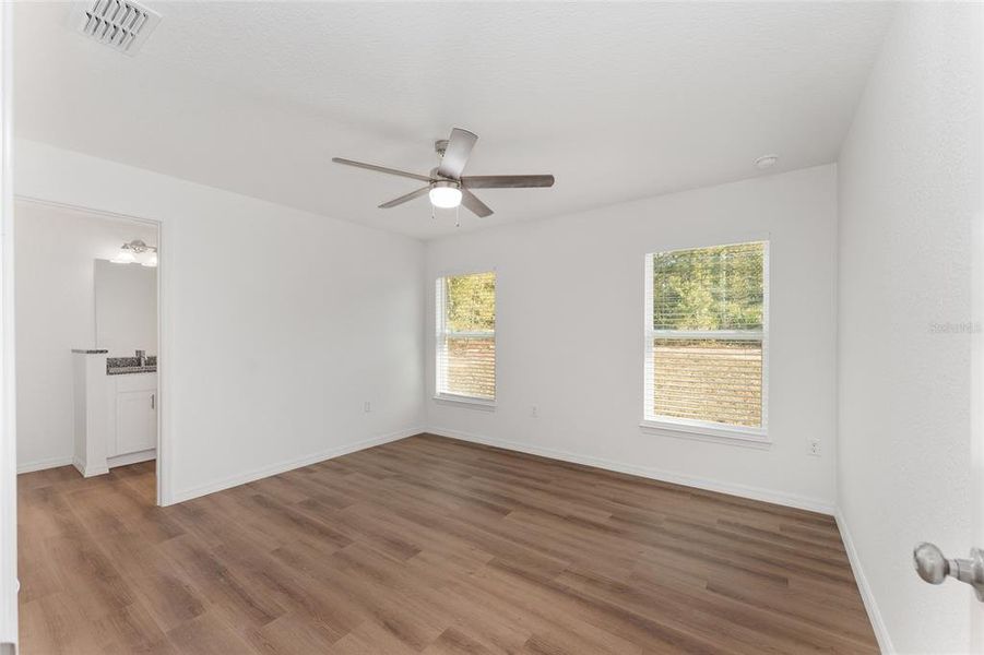 Primary bedroom with LVP flooring