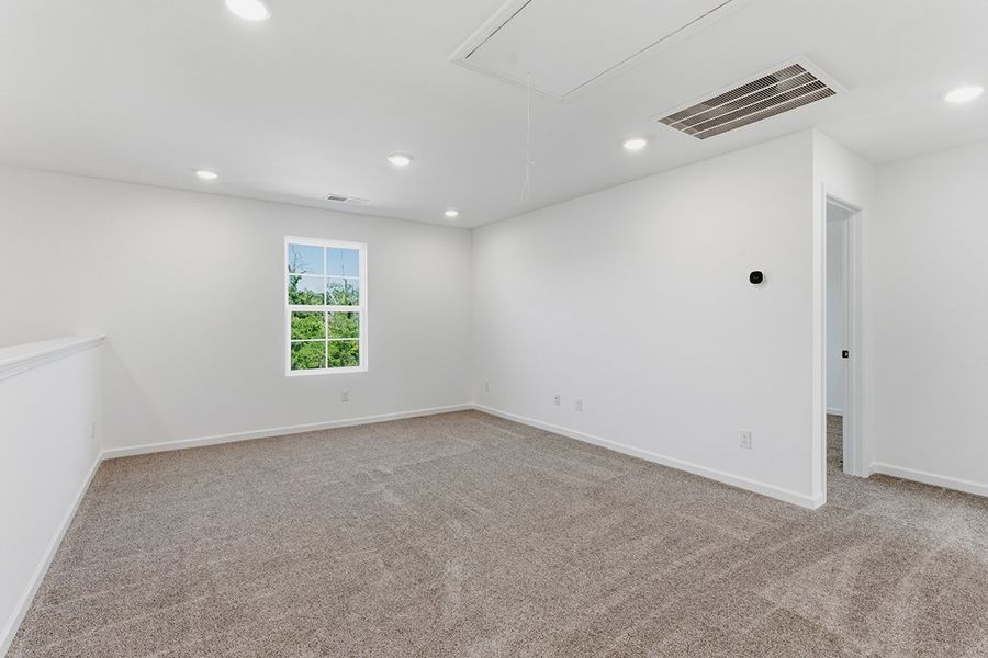 A room with a window and a carpet.