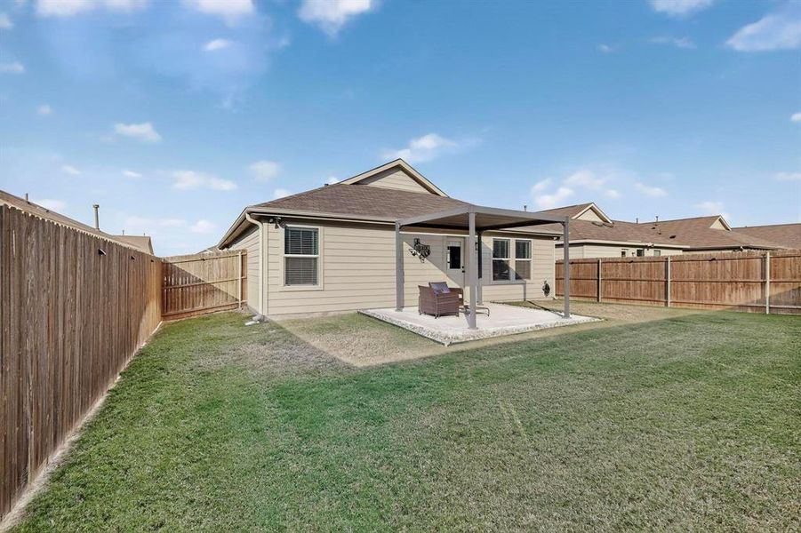 Back of house with a patio, a shingled roof, and a fenced backyard Back of house with a patio, a shingled roof, and a fenced backyard