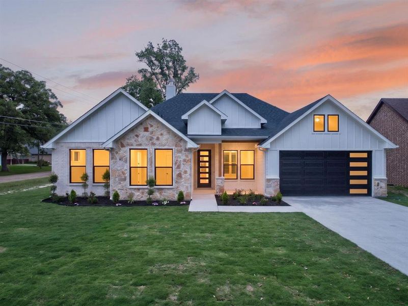 Contemporary exterior featuring white brick and natural stone accents Contemporary exterior featuring white brick and natural stone accents