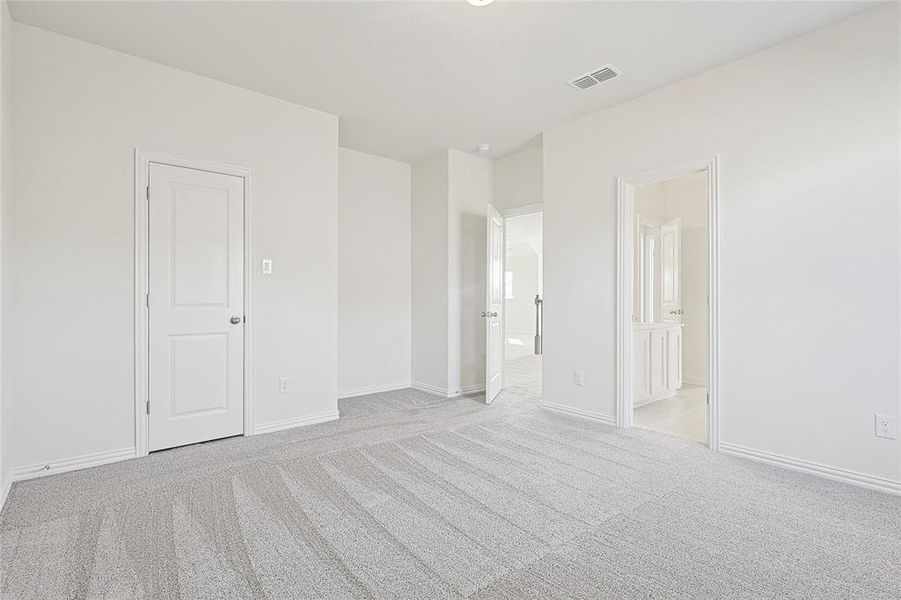 Unfurnished bedroom featuring light colored carpet and baseboards Unfurnished bedroom featuring light colored carpet and baseboards