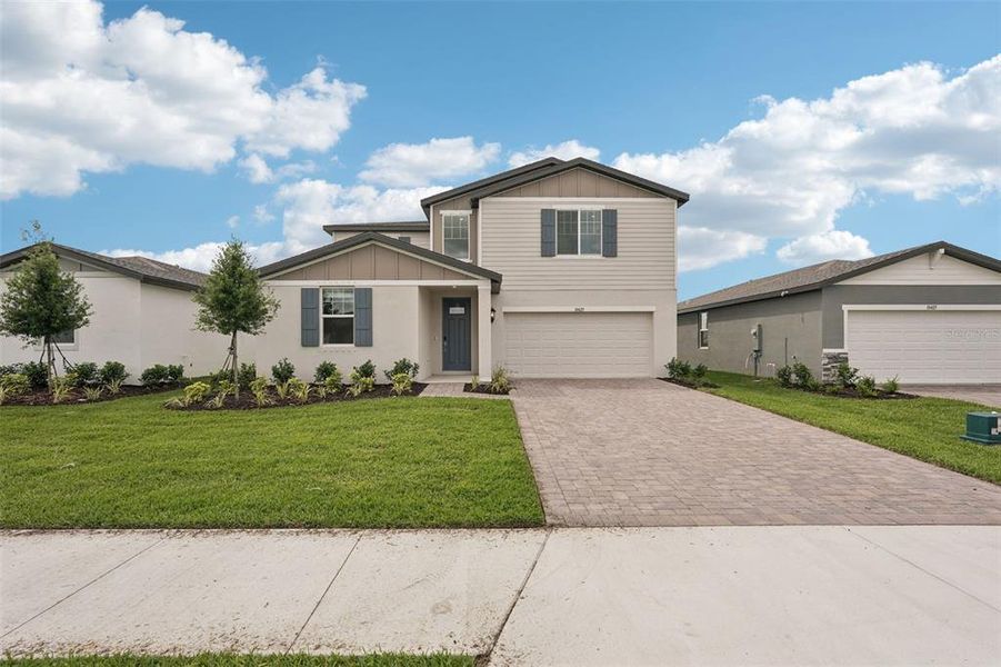 Front exterior of a new home in Oakfield Trails - Classic Series, Parrish, FL, highlighting curb appeal (Image 1). Front exterior of a new home in Oakfield Trails - Classic Series, Parrish, FL, highlighting curb appeal (Image 1).