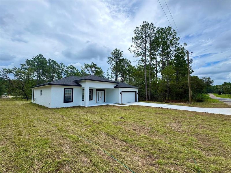 Front exterior of a new home in , Citrus Springs, FL, highlighting curb appeal (Image 16). Front exterior of a new home in , Citrus Springs, FL, highlighting curb appeal (Image 16).