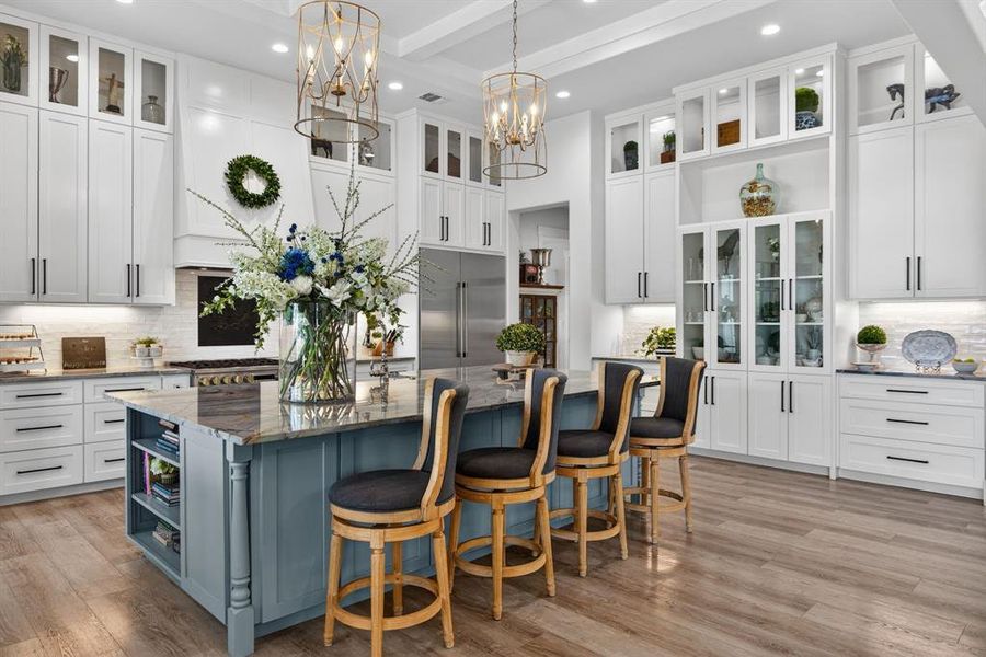 The kitchen is a beautiful extension of the massive grand room. This island provides the perfect place to mingle, serve, and enjoy this gourmet kitchen.
