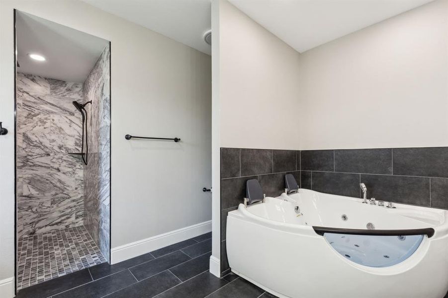 Primary bathroom with jetted tub for 2, and walk in shower. Primary bathroom with jetted tub for 2, and walk in shower.