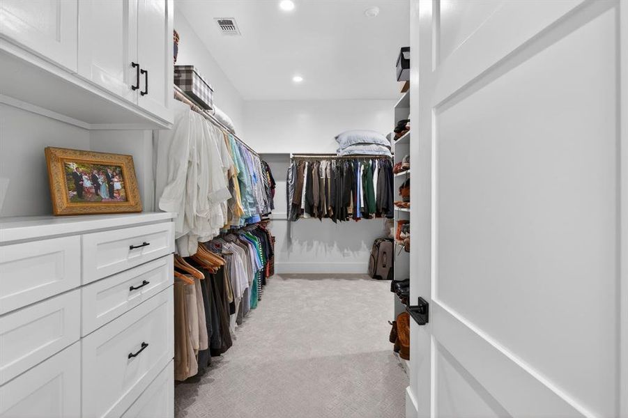 The is the OTHER primary closet that also is equipped with numerous built-in areas.