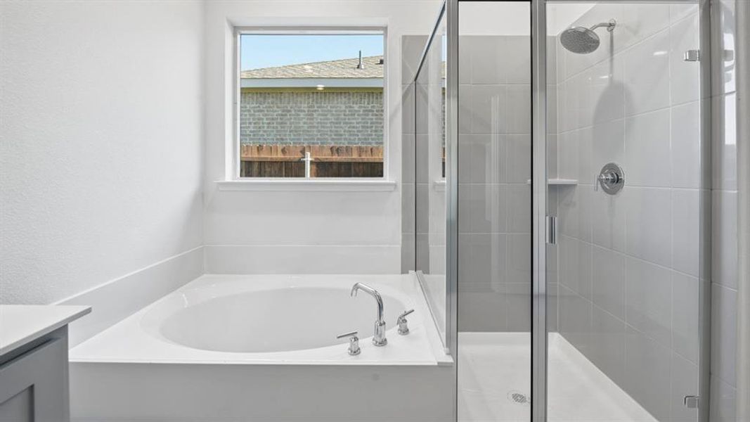 Full bath featuring a bath, vanity, and a shower stall Full bath featuring a bath, vanity, and a shower stall