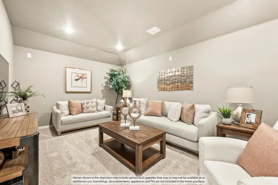 Living room with beige sofas, wood coffee table, and neutral carpet under vaulted ceiling