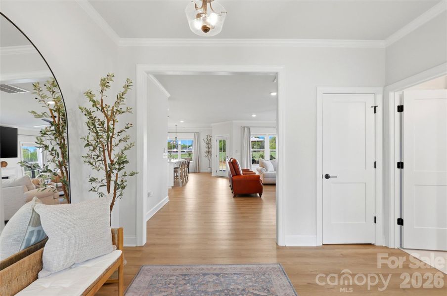A bright, airy foyer welcomes you with warm LVP flooring, crisp neutral tones, and a wide, open entry that seamlessly draws you into the heart of the home.