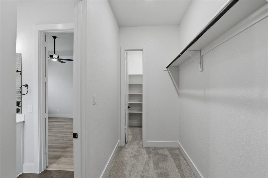 Walk in closet with ceiling fan