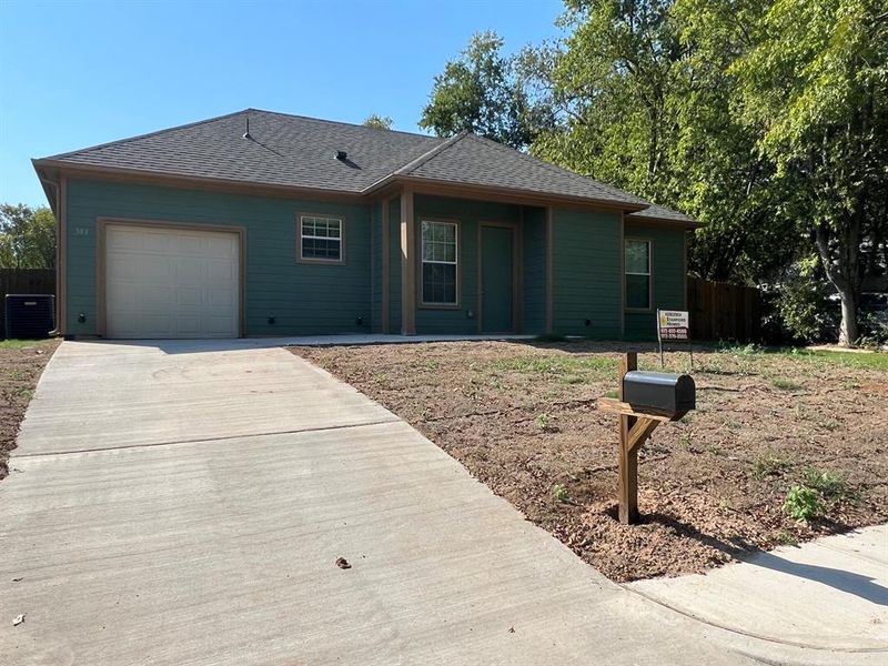 Ranch-style house featuring a garage and central AC