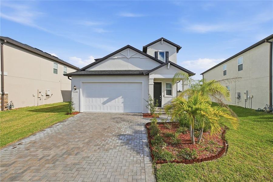 Front exterior of a new home in Stonegate Preserve, Palmetto, FL, highlighting curb appeal (Image 29).