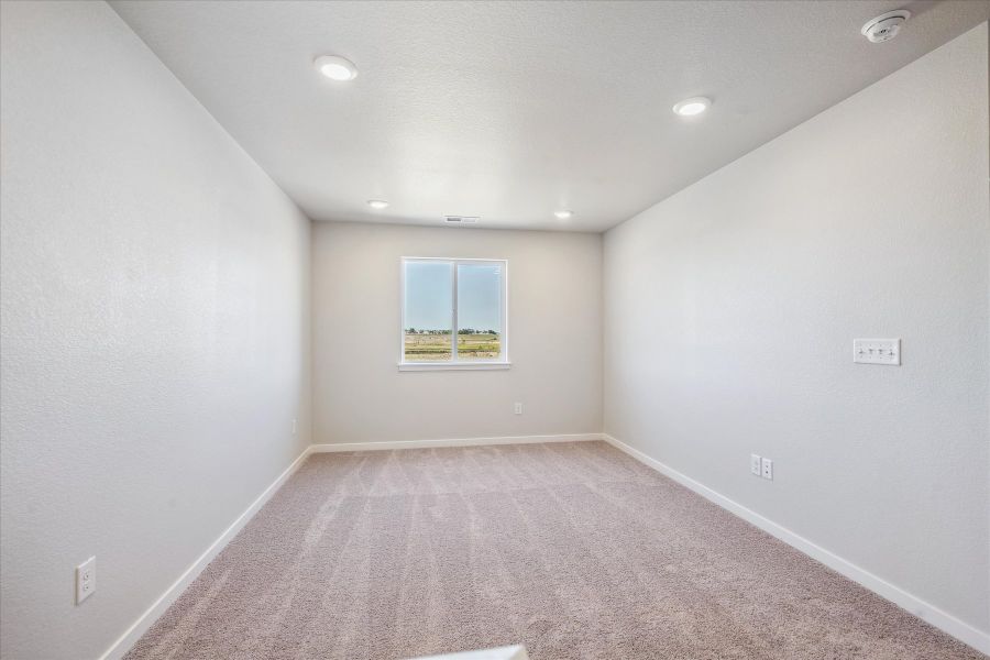 A room with a carpet and a window. A room with a carpet and a window.