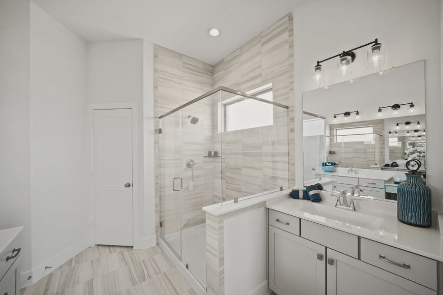 Representative furnished interior of a home built from the Athens by Chesmar Homes in Sunterra, Katy (Image 14).