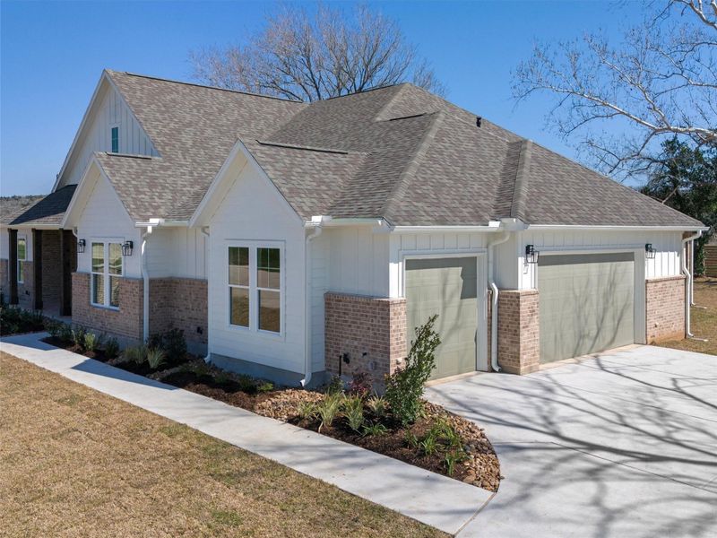Front exterior of a new home in , Smithville, TX, highlighting curb appeal (Image 22).