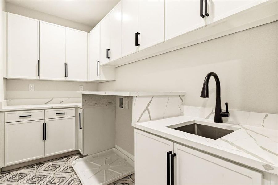 Laundry area with washer hookup and cabinet space