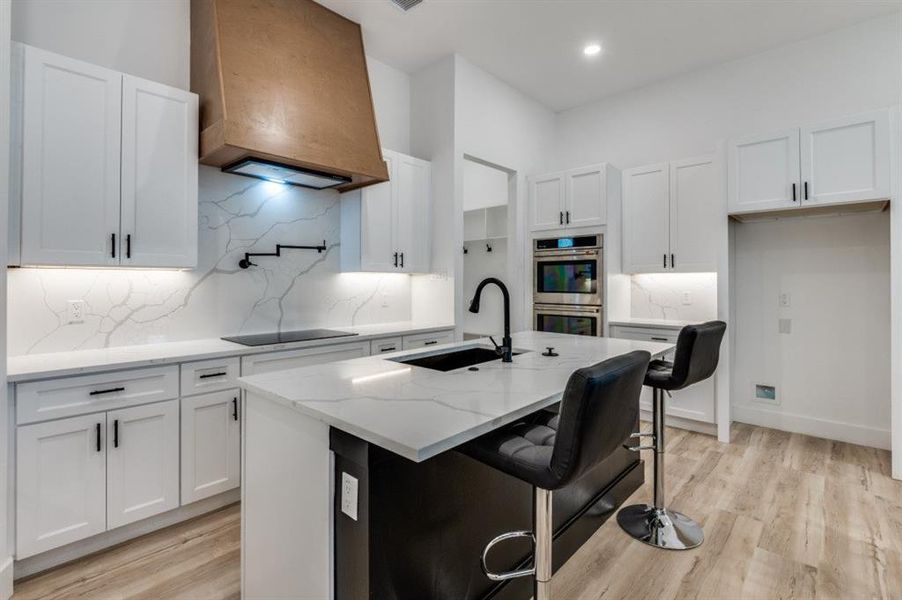 Impressive wraparound chef’s kitchen designed for entertaining, complete with dual islands seating nine guests, double ovens, pot filler, dramatic oversized vent hood, and a spacious walk-in pantry with integrated outlets for small appliances. Impressive wraparound chef’s kitchen designed for entertaining, complete with dual islands seating nine guests, double ovens, pot filler, dramatic oversized vent hood, and a spacious walk-in pantry with integrated outlets for small appliances.