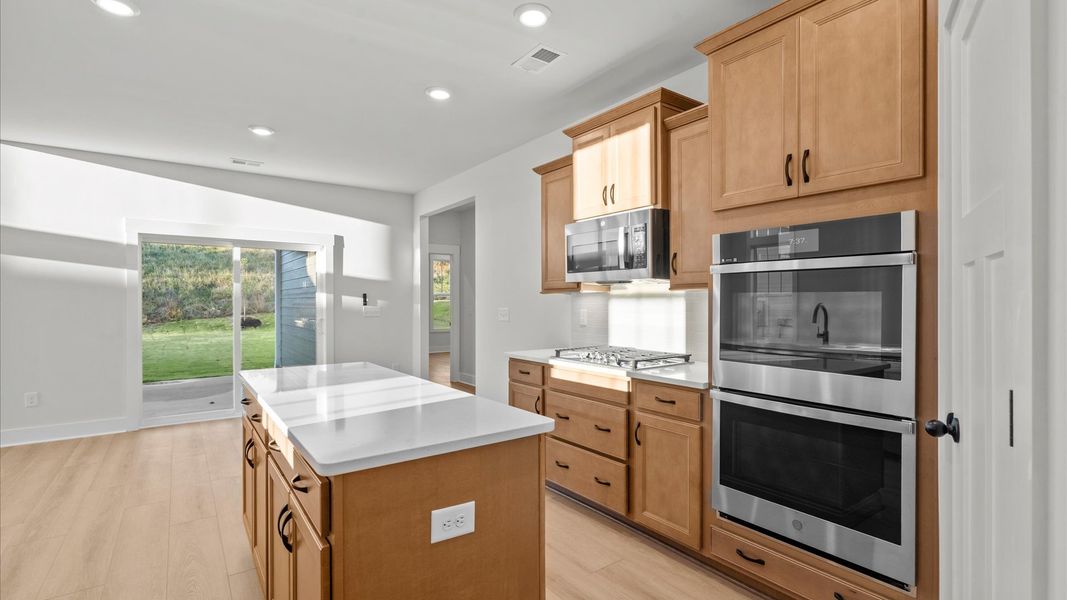 Elegant and compact island anchors this tasteful kitchen with high standards and timeless appeal