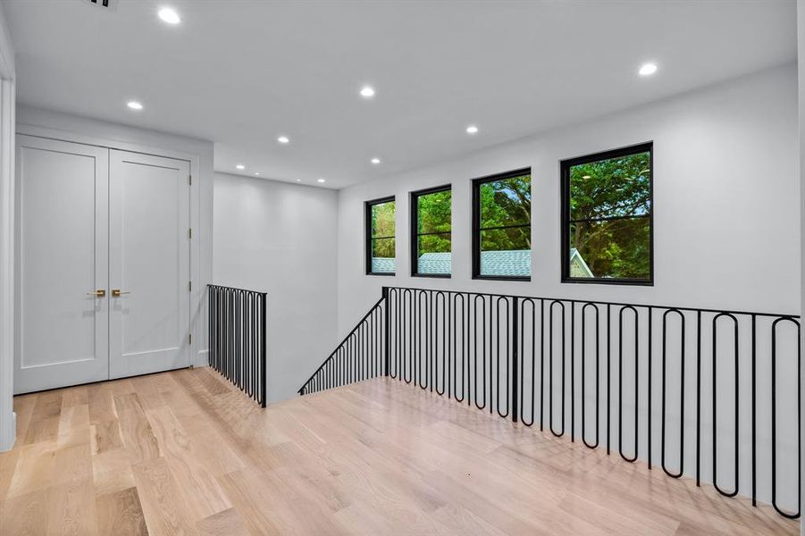 Hallway with light hardwood / wood-style flooring