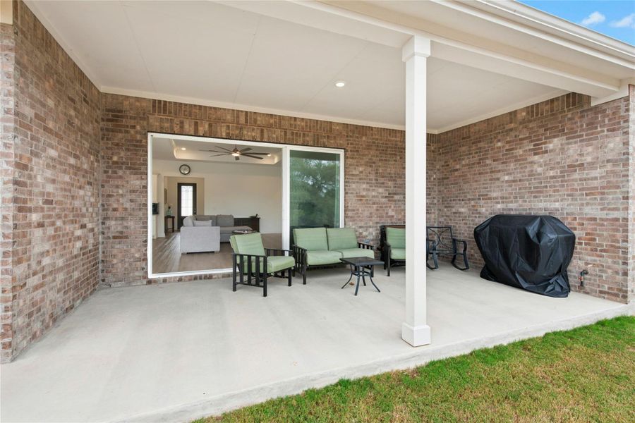 Covered back porch with glass slider doors from living room