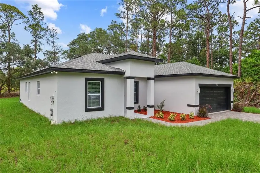 Front exterior of a new home in , Indian Lake Estates, FL, highlighting curb appeal (Image 1). Front exterior of a new home in , Indian Lake Estates, FL, highlighting curb appeal (Image 1).