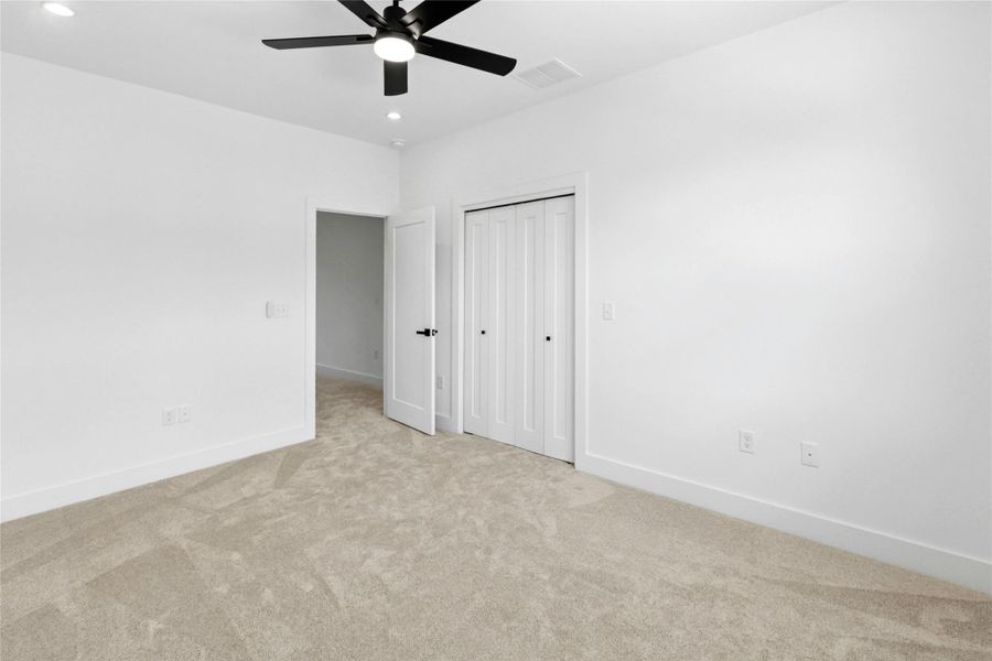 Unfurnished bedroom featuring carpet floors, recessed lighting, ceiling fan, and a closet