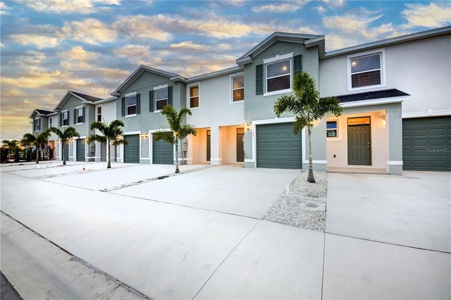 Front exterior of a new home in The Gardens at Bay Street, Sarasota, FL, highlighting curb appeal (Image 2). Front exterior of a new home in The Gardens at Bay Street, Sarasota, FL, highlighting curb appeal (Image 2).