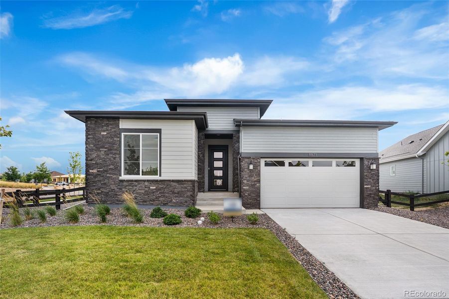 Front exterior of a new home in Hilltop at Inspiration, Aurora, CO, highlighting curb appeal (Image 20).