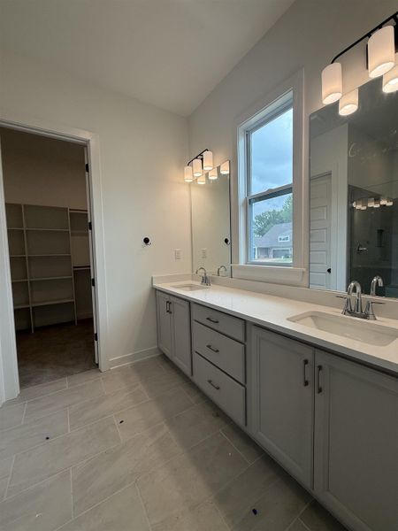 Double vanity with gray cabinetry, white countertops, and dual rectangular sinks