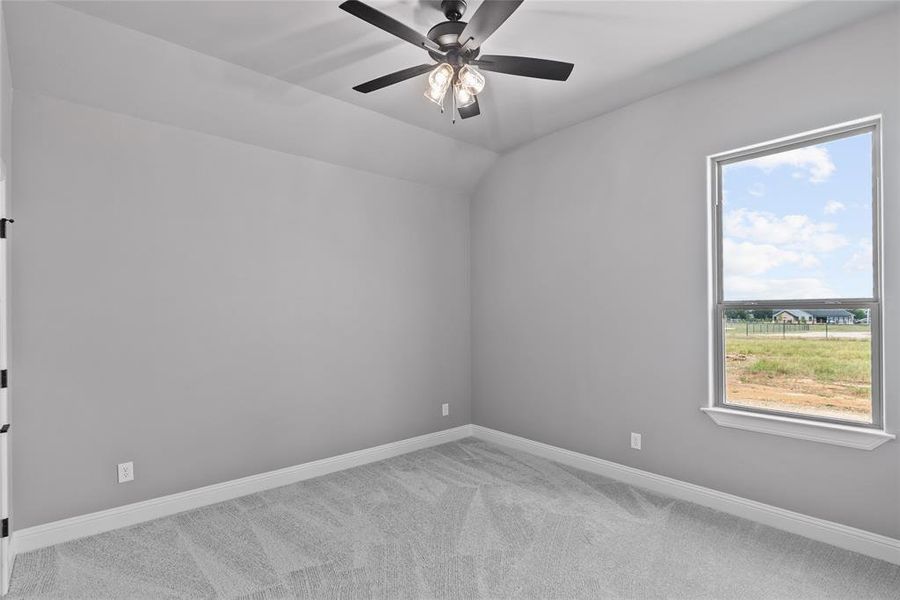 Empty room featuring carpet flooring and ceiling fan