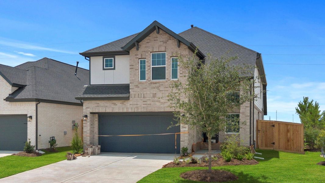 Front exterior of a new home in Jordan Ranch, Fulshear, TX, highlighting curb appeal (Image 1). Front exterior of a new home in Jordan Ranch, Fulshear, TX, highlighting curb appeal (Image 1).